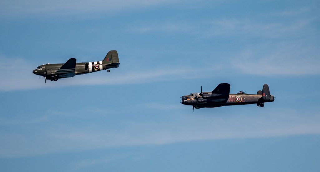 Two World War Two RAF aircraft flying past, a DC3 and a Lancaster.