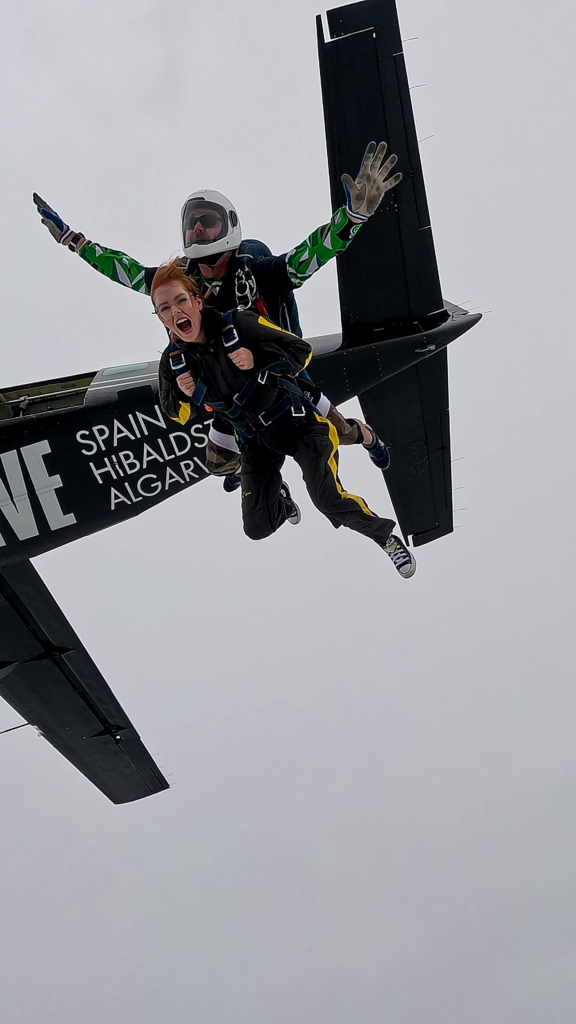 A view upward from on skydiver of a tandem pair parachute jump, just after they leave the jump plane