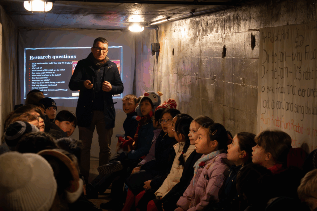 Children listening to Professor Reynolds telling them about the shelter